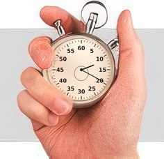 Hand holding a stopwatch Hand holding a stopwatch
